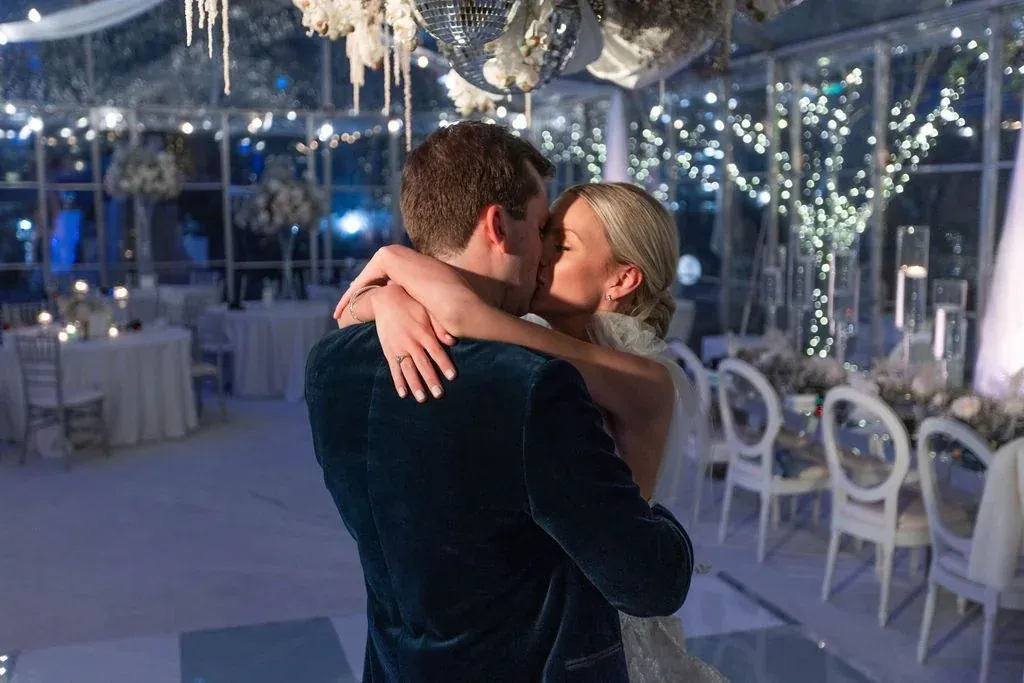 A couple embracing under terrace lights