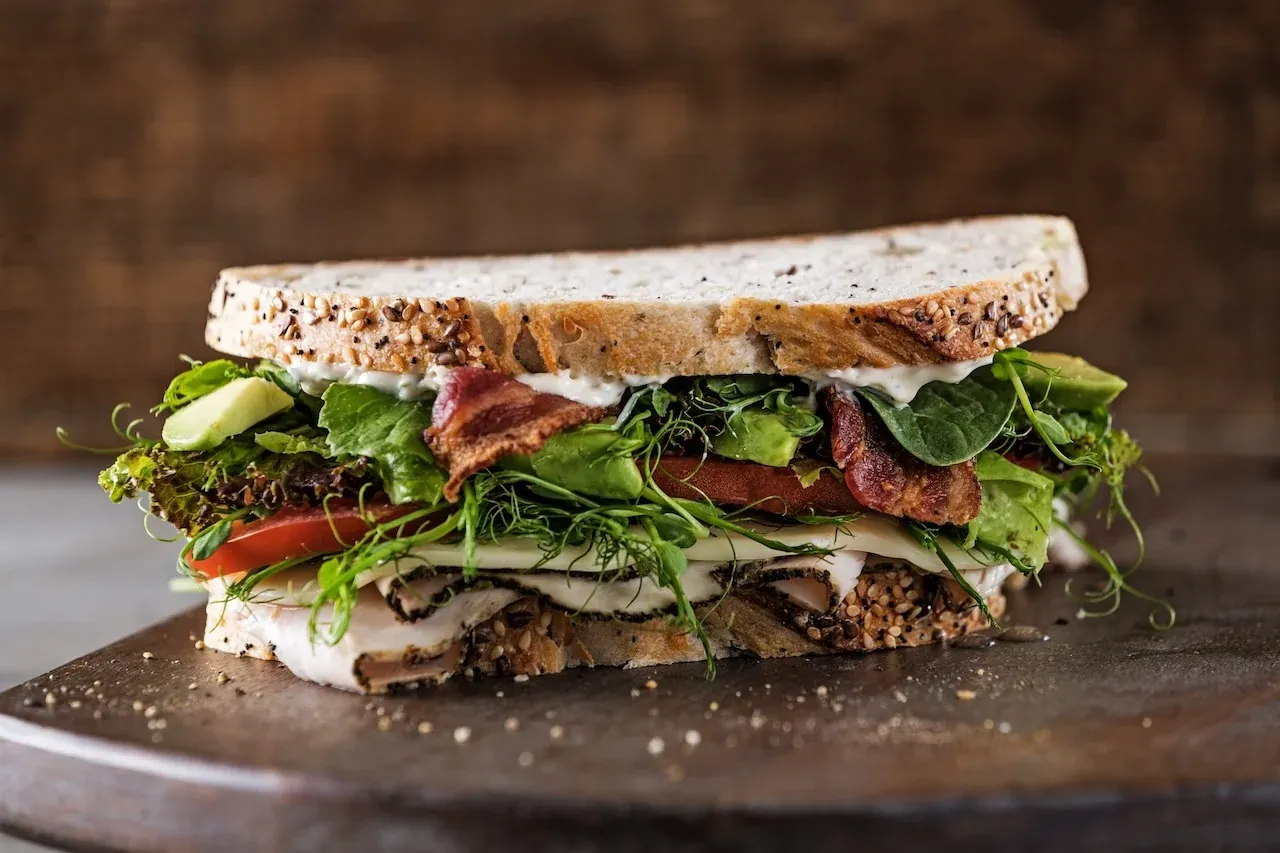 A West Coast turkey club sandwich on toasted wheatberry bread