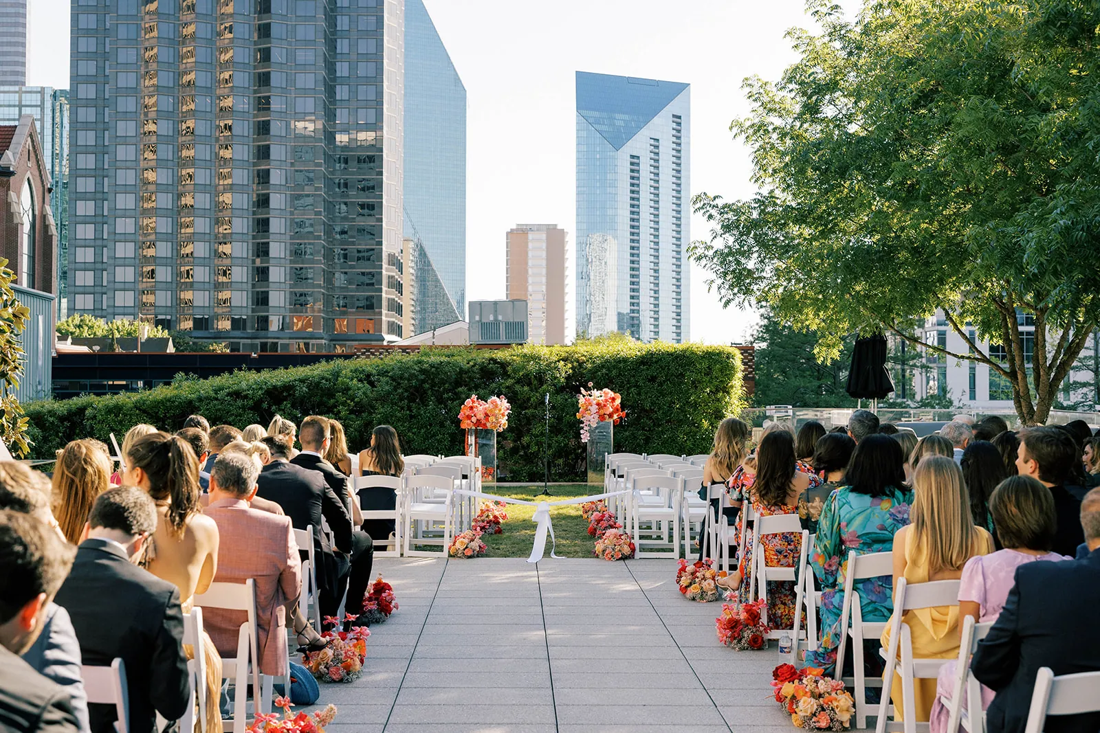 A wedding ceremony on The Artisan rooftop terrace with the Dallas skyline behind